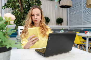 Young female freelancer work in cafe with netbook. stock photo NULLED
