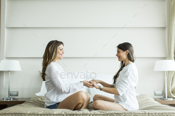 Young women on the bed stock photo NULLED