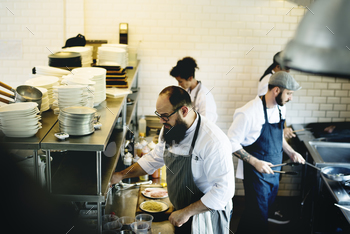 Group of chefs working in the kitchen stock photo NULLED