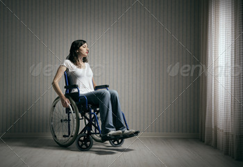 Sad woman sitting on wheelchair