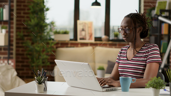 African american freelancer typing information on laptop stock photo NULLED
