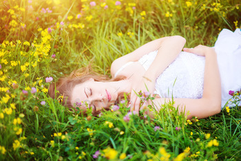 Beautiful woman on a meadow. stock photo NULLED