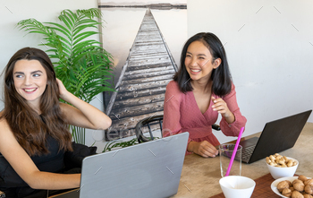 Cheerful multiethnic freelancers laughing at joke stock photo NULLED