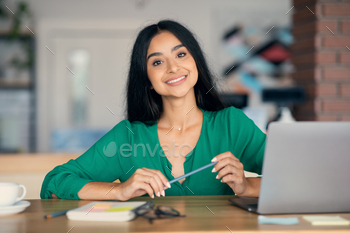 Creative indian woman freelancer working at cafe stock photo NULLED