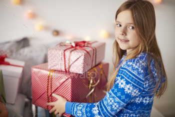 Cute girl holding stock of Christmas presents stock photo NULLED