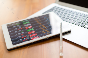 Digital stock market chart on white tablet screen stock photo NULLED