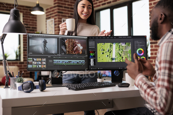 Diverse freelancers editing film footage on computer stock photo NULLED