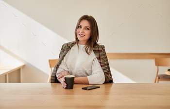 Freelancer drinking coffee during work stock photo NULLED