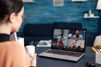 Freelancer having group online meeting on laptop stock photo NULLED