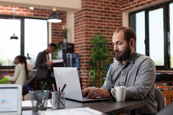 Freelancer man typing ideas for marketing project stock photo NULLED