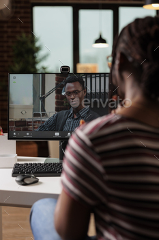 Freelancer talking with client on videoconference, back view stock photo NULLED