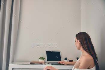 Freelancer working online on laptop at home stock photo NULLED