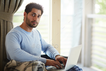 Handsome freelance community manager working at home stock photo NULLED
