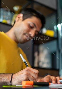 Male freelancer making notes in cafe stock photo NULLED