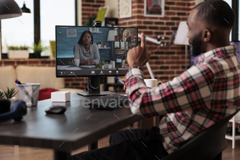 Male freelancer using online teleconference call stock photo NULLED