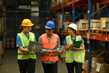Middle aged manager and young workers inspecting stock. stock photo NULLED
