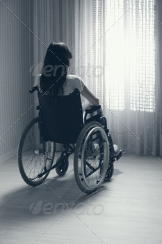Sad woman sitting on wheelchair