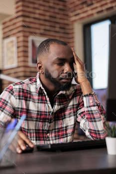 Tired exhausted freelancer working from home stock photo NULLED