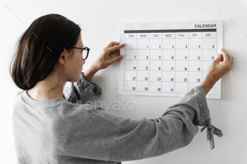 Woman checking the calendar stock photo NULLED