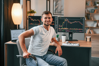 Young stock broker is working in the office by using computer stock photo NULLED